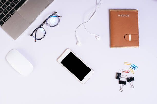 istock Top view cell phone on white desk 1154715372
