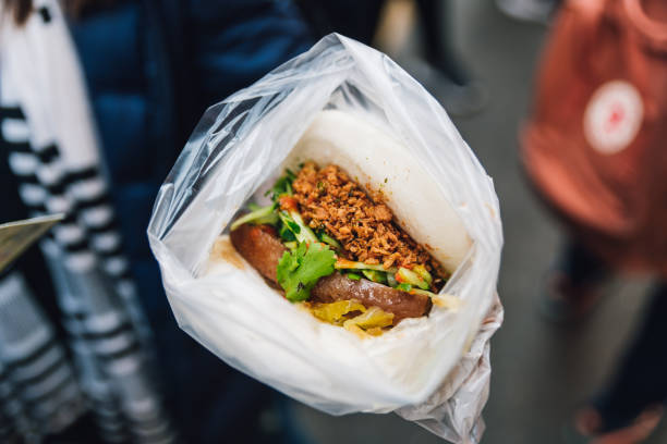 Pork Belly Bun (Gua Bao): Steaming white bun with warm braised pork belly in street food market at Yuchi Township, Nantou County, Taiwan. Pork Belly Bun (Gua Bao): Steaming white bun with warm braised pork belly in street food market at Yuchi Township, Nantou County, Taiwan. dong stock pictures, royalty-free photos & images