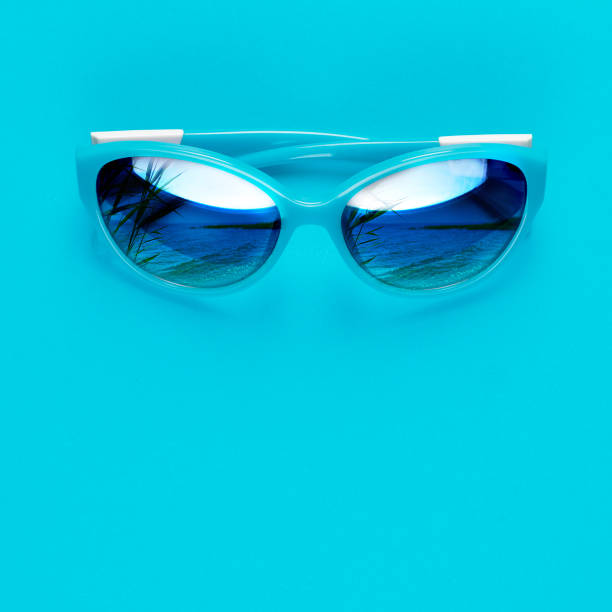 istock Stylish blue sunglasses on blue background. Summer is coming concept. 1154720879