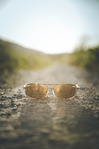 Sunglasses are lying on the floor, country lane
