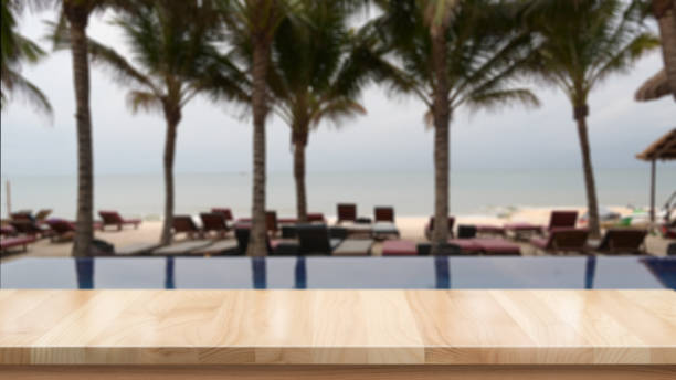 istock Wood table top and blurred summer beach background 1154721399