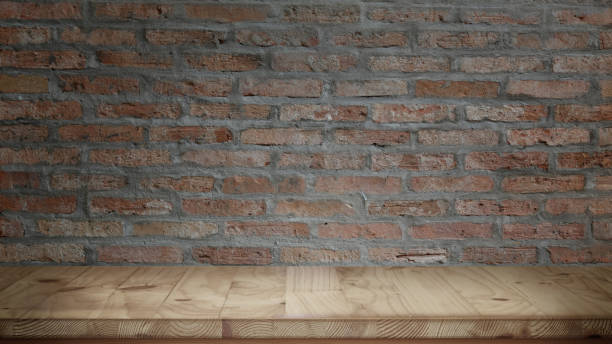 istock Wood table and red brick wall background 1154721465