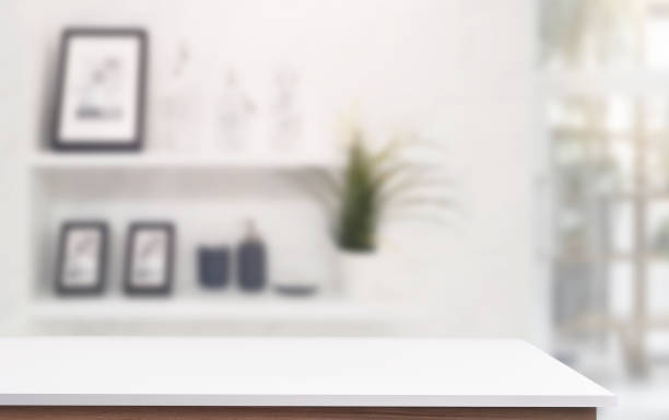 istock White top table with blur living room background, copy space for product display or montage. 1154721477