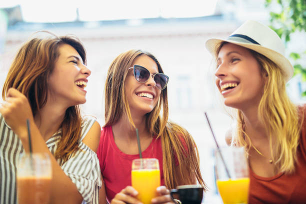 istock Three beautiful friends in a cafe using digital tablet and having fun 1154721699