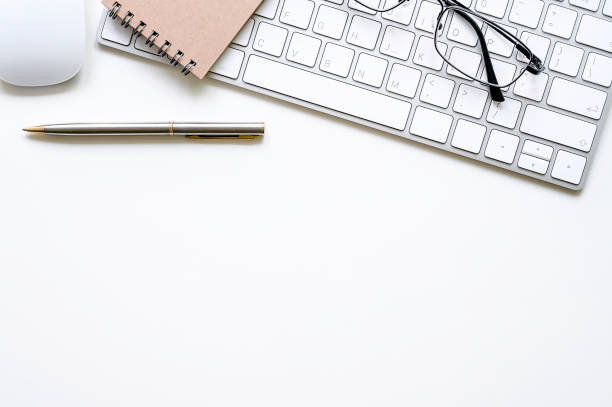 istock White office desk with white keyboard and supplies. 1154722213