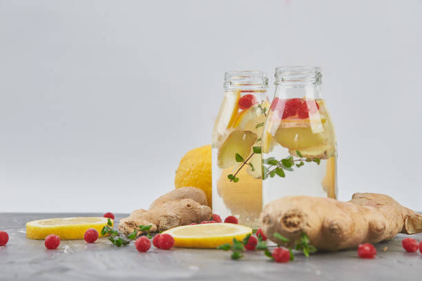 istock Detox water in bottles with cranberrie, ginger, lemon, mint 1154722462