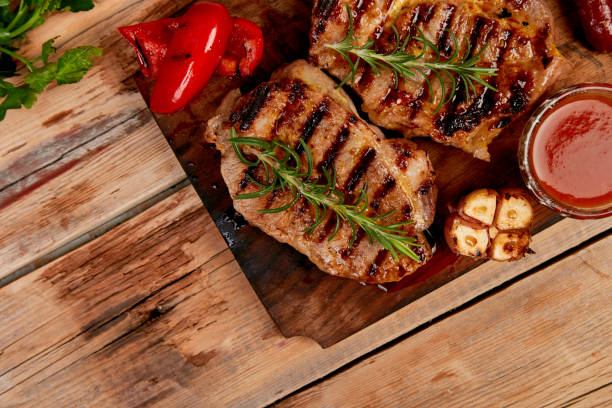 istock Steak pork grill on wooden cutting board 1154722483