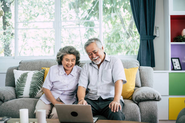 istock Senior couple talking with laptop computer 1154723440