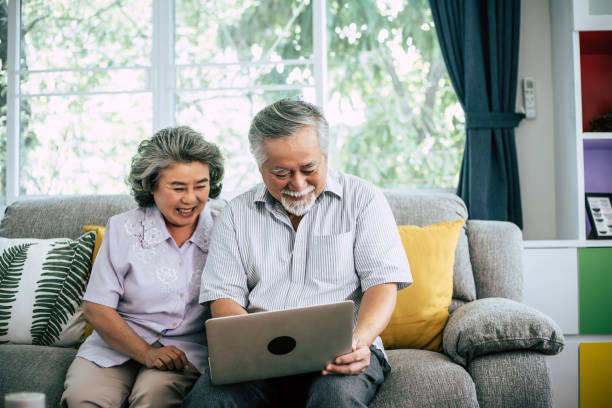 istock Senior couple talking with laptop computer 1154723487