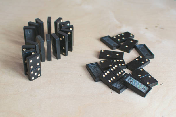 istock black dominoes on light wooden background 1154725838