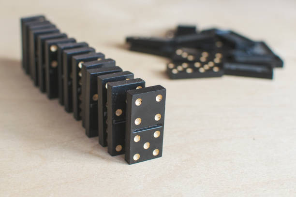 istock black dominoes on light wooden background 1154725845