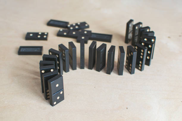 istock black dominoes on light wooden background 1154725868