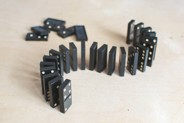 istock black dominoes on light wooden background 1154725880