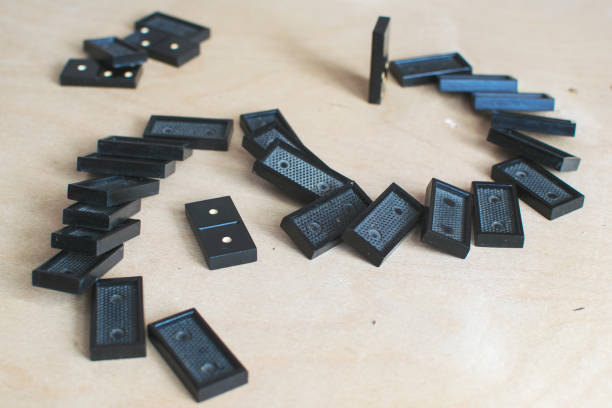 istock black dominoes on light wooden background 1154725882