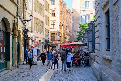 People strolling around in the old town district of Lyon, France, during a day in the early summer.