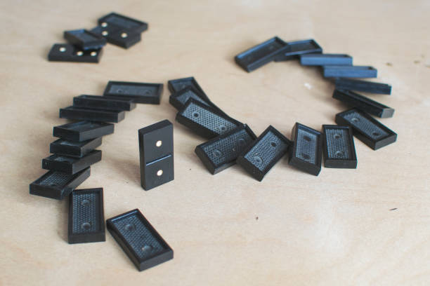 istock black dominoes on light wooden background 1154725937
