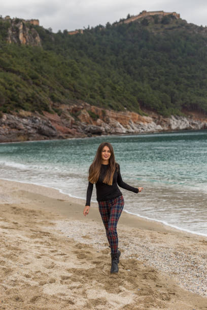 istock beautiful fit female running at winter beach 1154727941