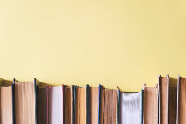 istock old books on bookshelves with yellow background 1154728354
