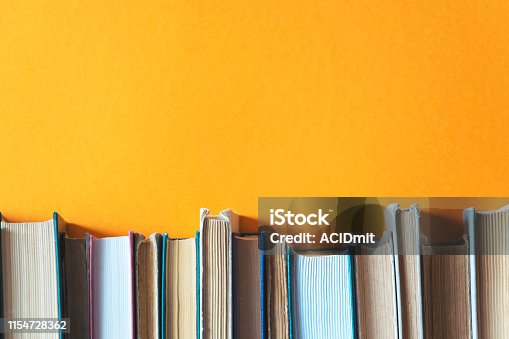 istock old books on bookshelves with orange background 1154728362