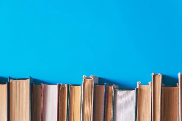 old books on bookshelves with blue background