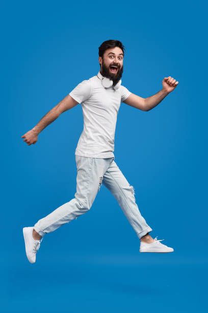 istock Excited hipster jumping and looking at camera 1154728675