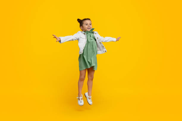 istock Cute girl smiling and jumping 1154728752