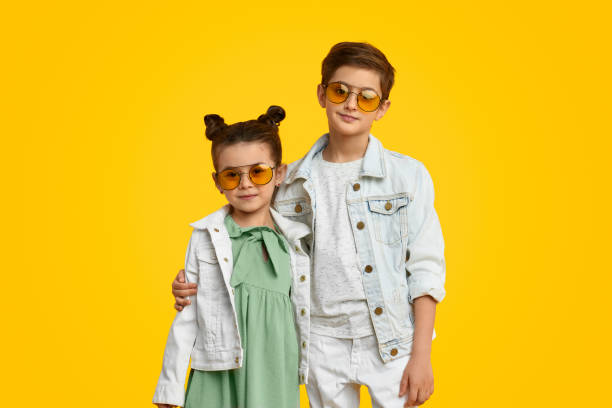 istock Stylish kids hugging and looking at camera 1154728771