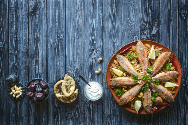 istock Arabian Fish Kabsa on a dark wooden background. 1154730565