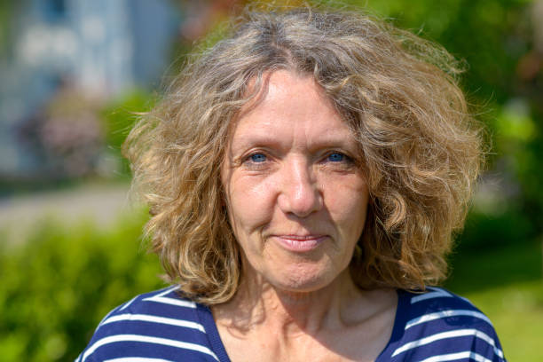 istock Attractive middle-aged woman in a garden 1154732242