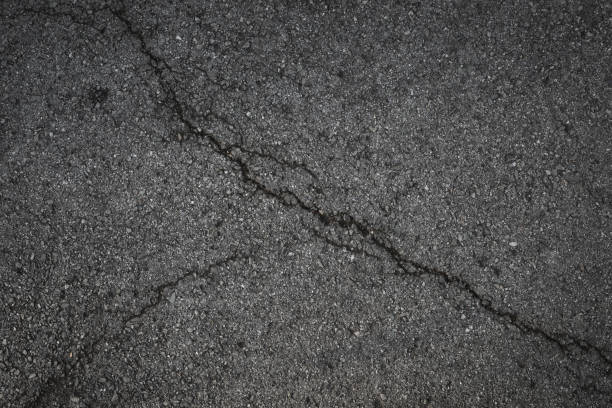 istock background texture of crack asphalt 1154733843