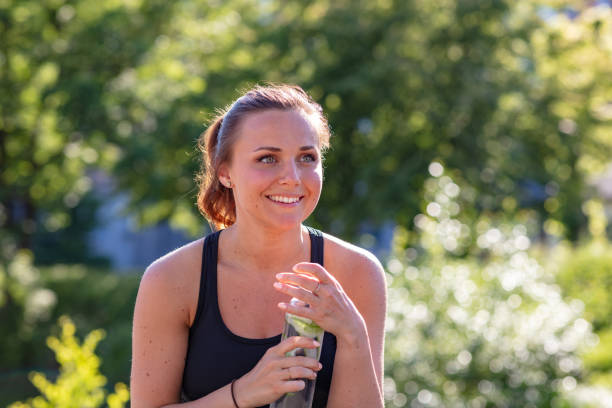 istock Woman drinking cucumber water 1154739360