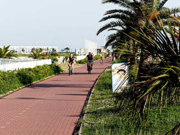 Sochi, Russia - May 18, 2019: a couple is riding bicycles on the embankment