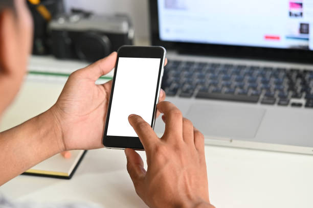 istock Cropped shot hands using mockup mobile phone on office desk. 1154744591