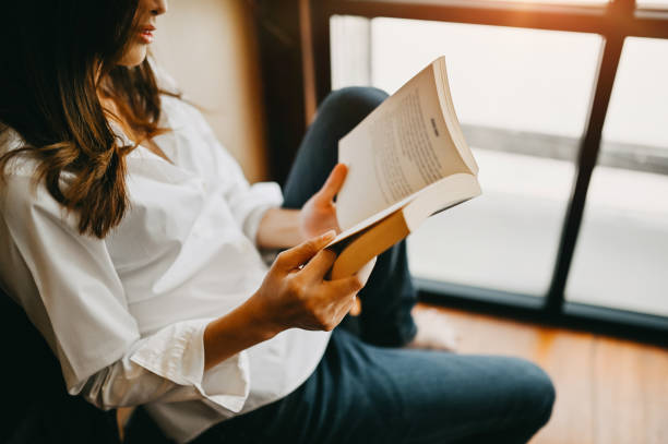 istock Cropped shot asian woman reading a book. 1154744758