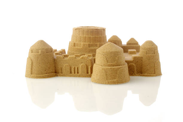 istock Sandcastle at the beach isolated on white background 1154747635