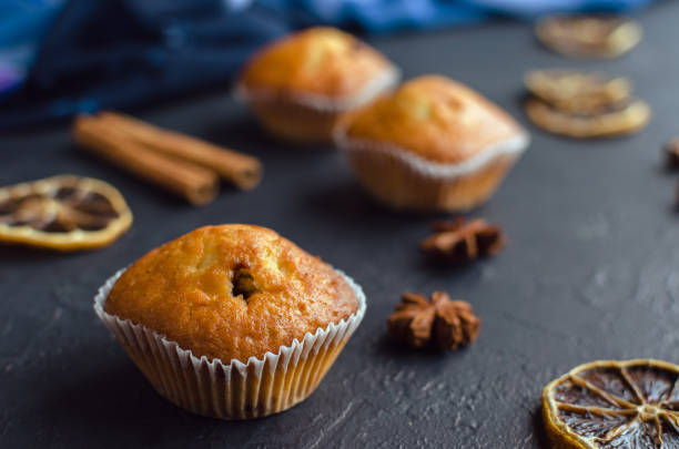 istock Sweet muffins with on dark textured background. 1154748190