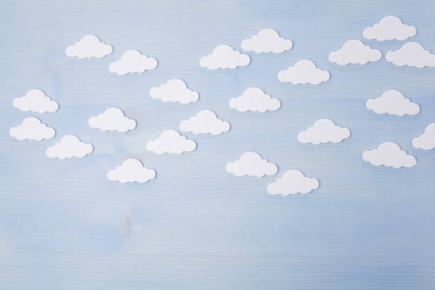 istock white clouds on a blue wooden background 1154748217