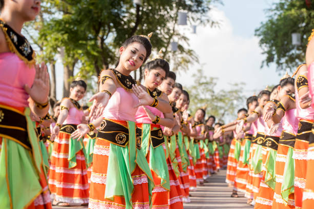 traditional dresst thai women at the Loy Krathong Festival in the Historical Park in Sukhothai in the Provinz Sukhothai in Thailand.   Thailand, Sukhothai, November, 2018