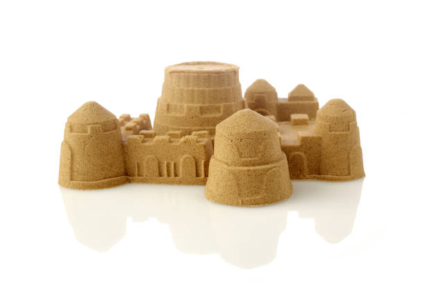 istock Sandcastle at the beach isolated on white background 1154748370