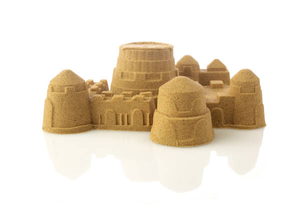 istock Sandcastle at the beach isolated on white background 1154748853