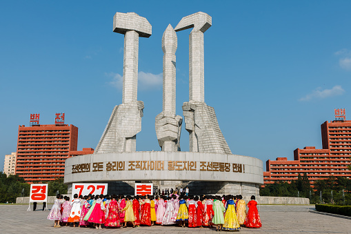 Pyongyang, North Korea - July 27, 2014: Korean girls are standing on the square in anticipation of the start of mass dances dedicated to the day of victory in the war.
