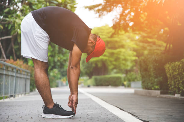 istock Young man runner stretching for warming up before running or working out 1154750489