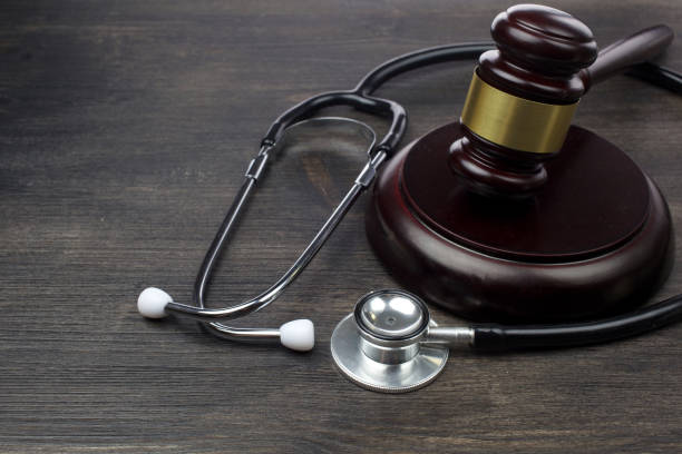istock Gavel and stethoscope on black wooden background 1154752461