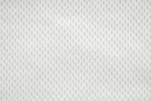 White sports clothing fabric jersey football shirt texture top view close up White sports clothing fabric jersey football shirt texture top view close up polyester photos stock pictures, royalty-free photos & images