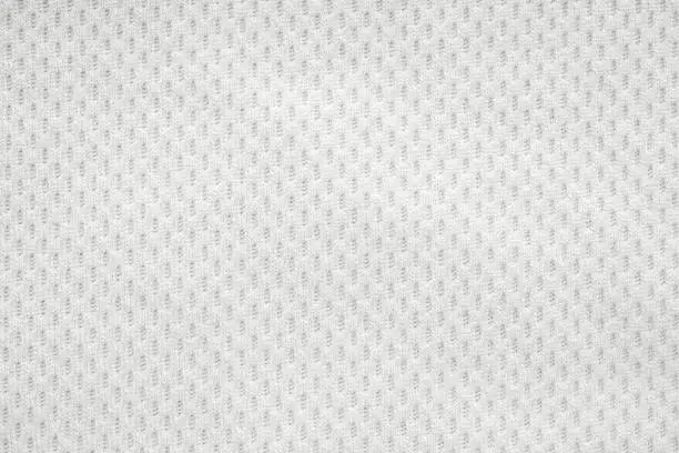 Photo of White sports clothing fabric jersey football shirt texture top view close up