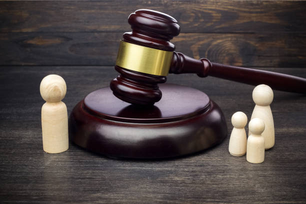 istock dad and mom with kids figures with gavel. divorce concept 1154753647