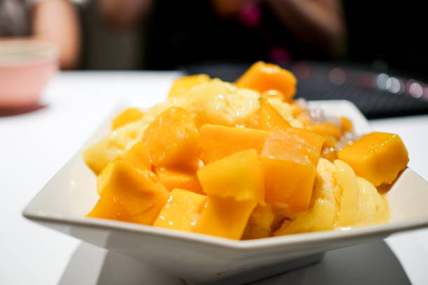 istock Fresh mango with ice cream in the restaurant. Close up. 1154753670