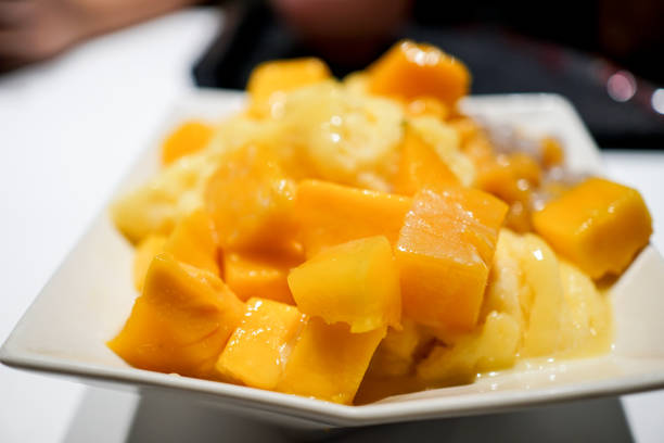 istock Fresh mango with ice cream in the restaurant. Close up. 1154753672