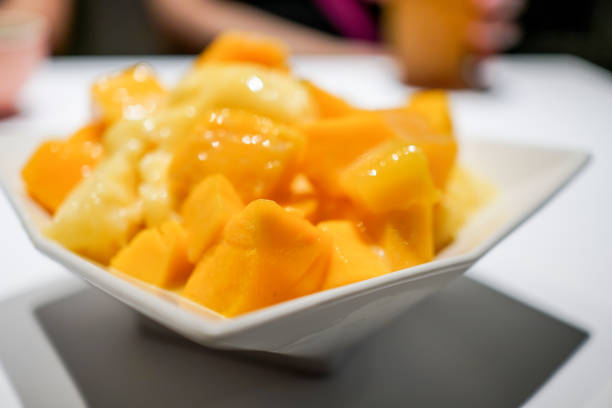 istock Fresh mango with ice cream in the restaurant. Close up. 1154753710