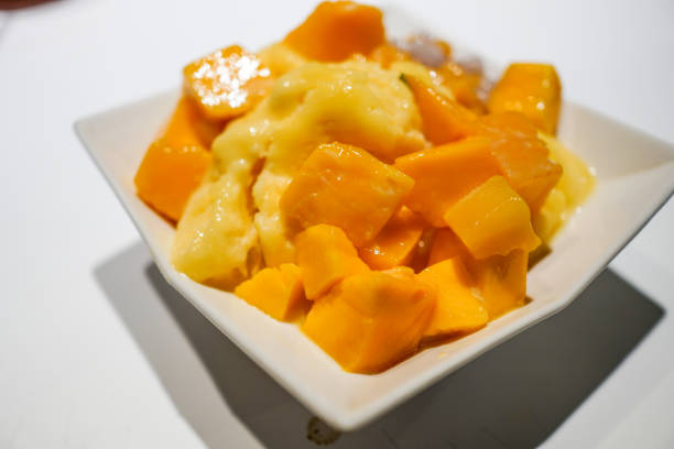 istock Fresh mango with ice cream in the restaurant. Close up. 1154753735